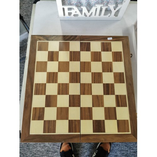 17 - A wooden chess board, a wooden key rack, and a boxed cheese plate with dishes.