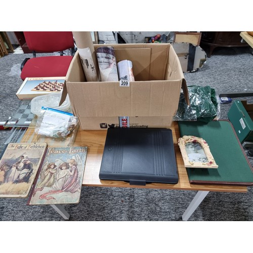 209 - A box of odds including 2 folios, a glass chess board and pieces and draught board and pieces, along... 