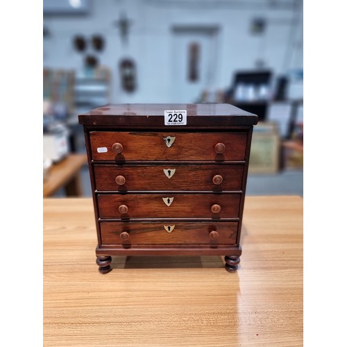 229 - A good quality antique Victorian table top chest of 4 drawers with small turned bun handles standing... 