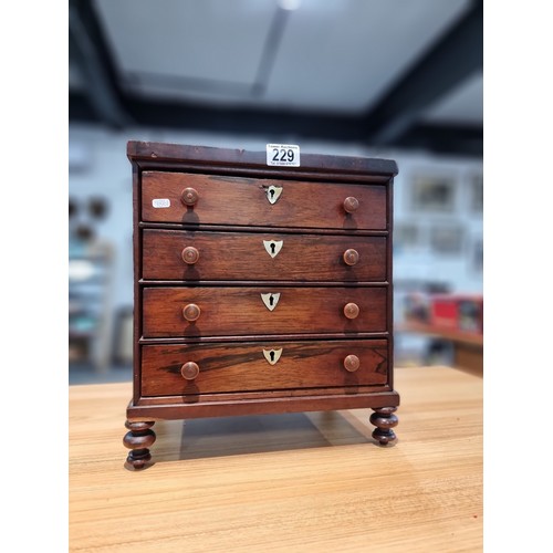 229 - A good quality antique Victorian table top chest of 4 drawers with small turned bun handles standing... 