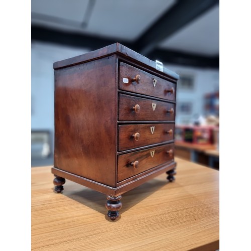 229 - A good quality antique Victorian table top chest of 4 drawers with small turned bun handles standing... 