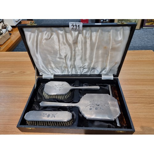 231 - A 4 piece hallmarked silver grooming set to include a hand mirror, 2 brushes and a comb, all with an... 