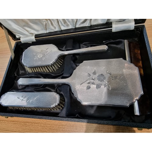 231 - A 4 piece hallmarked silver grooming set to include a hand mirror, 2 brushes and a comb, all with an... 