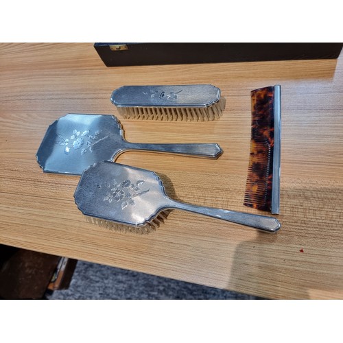 231 - A 4 piece hallmarked silver grooming set to include a hand mirror, 2 brushes and a comb, all with an... 