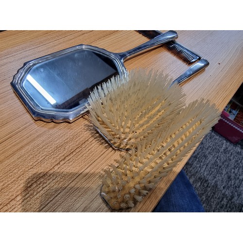 231 - A 4 piece hallmarked silver grooming set to include a hand mirror, 2 brushes and a comb, all with an... 