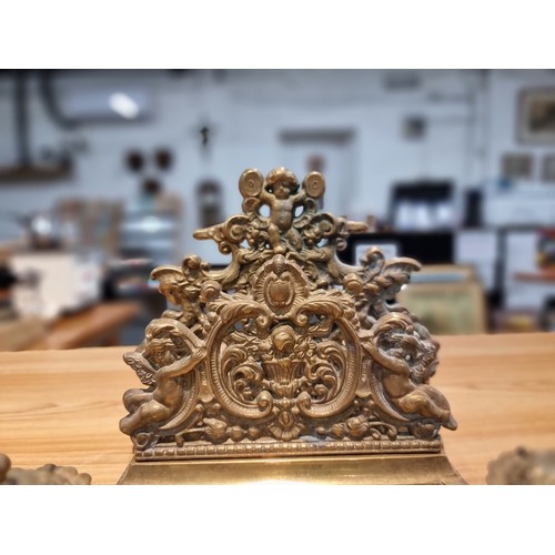 237 - A Victorian ornate brass desk stand and double inkwells featuring an ornate cherub design in good cl... 