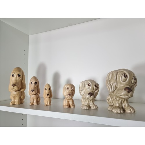 135C - 2 matching graduated sets of Sylvac ceramic dogs to include a set of 3 sad long eared dogs and a set... 