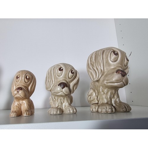 135C - 2 matching graduated sets of Sylvac ceramic dogs to include a set of 3 sad long eared dogs and a set... 