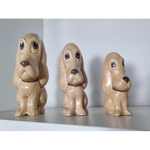 135C - 2 matching graduated sets of Sylvac ceramic dogs to include a set of 3 sad long eared dogs and a set... 