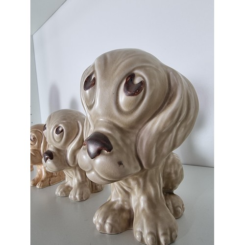 135C - 2 matching graduated sets of Sylvac ceramic dogs to include a set of 3 sad long eared dogs and a set... 