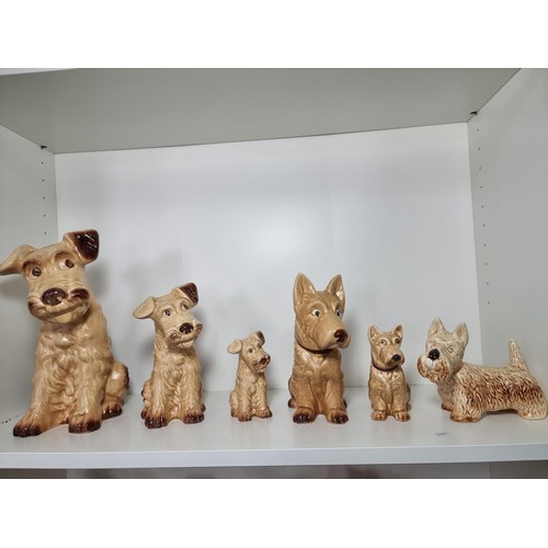 135D - A rare vintage set of graduated dogs by Sylvac to include a set of 3 graduated brown terrier dogs, a... 