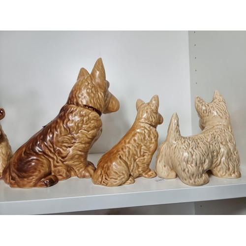 135D - A rare vintage set of graduated dogs by Sylvac to include a set of 3 graduated brown terrier dogs, a... 