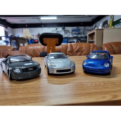 188 - 3 large die-cast model cars by Maisto, all are 1/4 scale to include an Audi TT, a Nissan 350Z and Vo... 