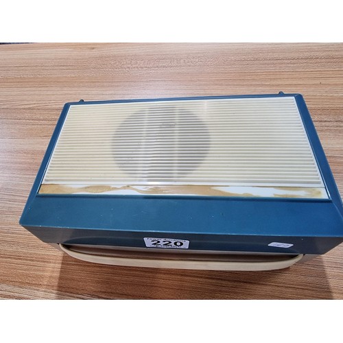 220 - A vintage retro tech Philip's battery operated portable record player with a built in speaker to the... 