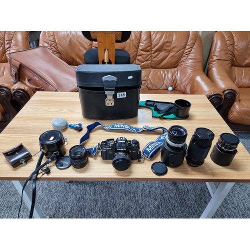 245 - A comprehensive vintage 35mm camera setup to include a Minolta X-700 camera, complete with 4 lenses,... 