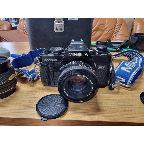 245 - A comprehensive vintage 35mm camera setup to include a Minolta X-700 camera, complete with 4 lenses,... 