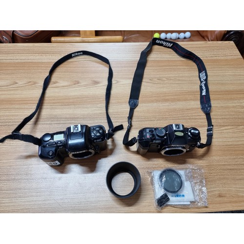 246 - 2 vintage Nikon 35mm camera bodies to include a Nikon F-601 and a Nikon F-301, both with Nikon strap... 