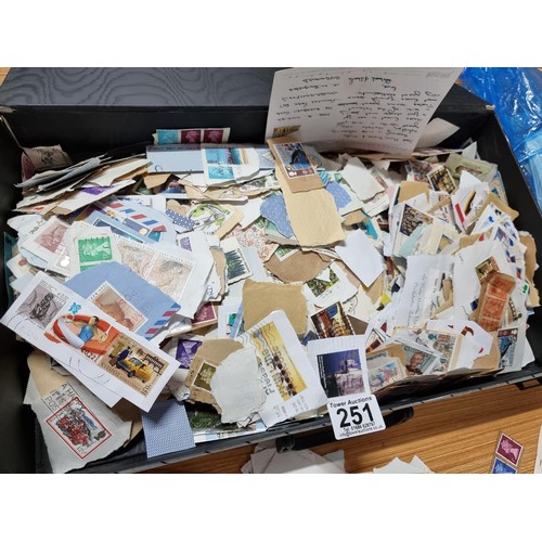 251 - A case containing a very large quantity of loose unsorted stamps mostly British and a bag full of mo... 