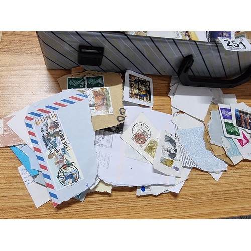 251 - A case containing a very large quantity of loose unsorted stamps mostly British and a bag full of mo... 