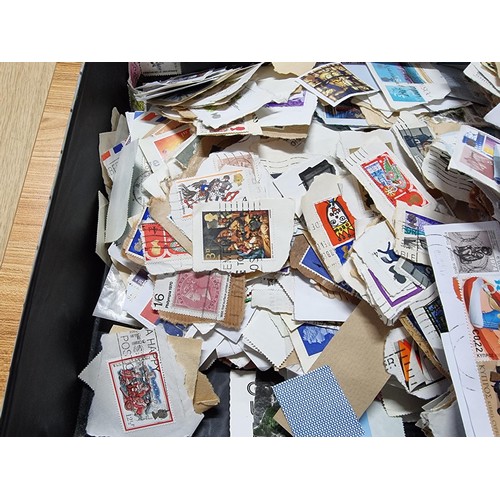 251 - A case containing a very large quantity of loose unsorted stamps mostly British and a bag full of mo... 