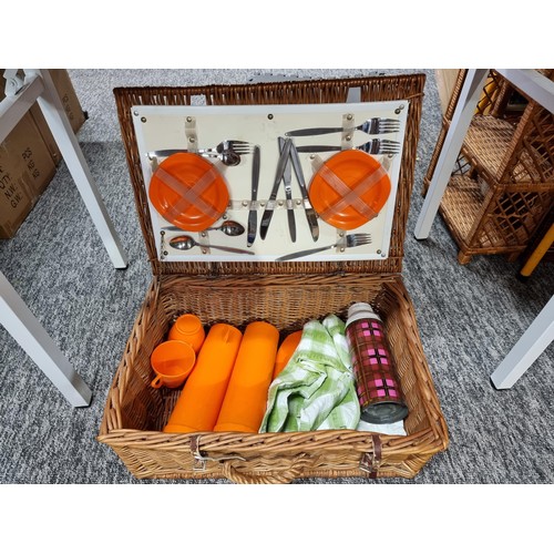 257 - A box of odds along with a picnic basket to include a gun cleaning kit, a quantity of plates by Jame... 