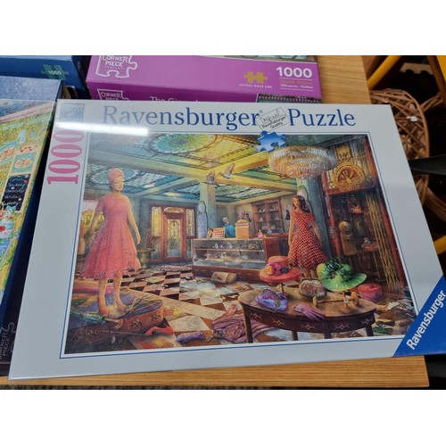 261 - A quantity of 6, 1000 piece puzzles to include a new and sealed puzzle by Ravensburger.