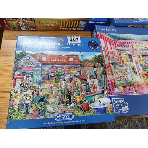 261 - A quantity of 6, 1000 piece puzzles to include a new and sealed puzzle by Ravensburger.