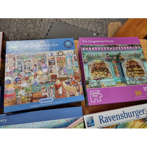 261 - A quantity of 6, 1000 piece puzzles to include a new and sealed puzzle by Ravensburger.