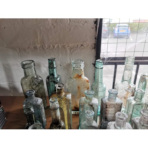 25 - Large quantity 46x of vintage and antique glass bottles some are branded Couchs Whooping Cough and A... 