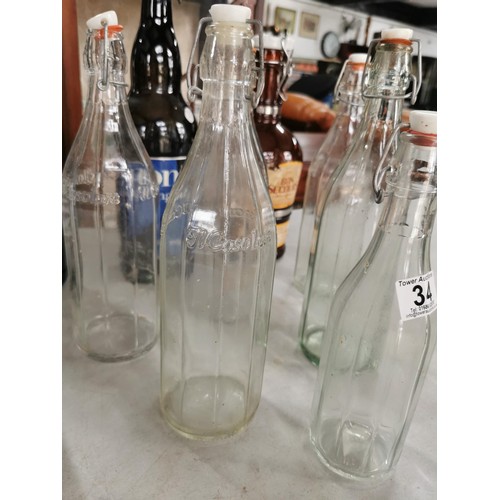 34 - Large quantity of bottles inc 5x Il Casolare bottles, 2x unbranded fizzy bottles 2x Montys large bee... 