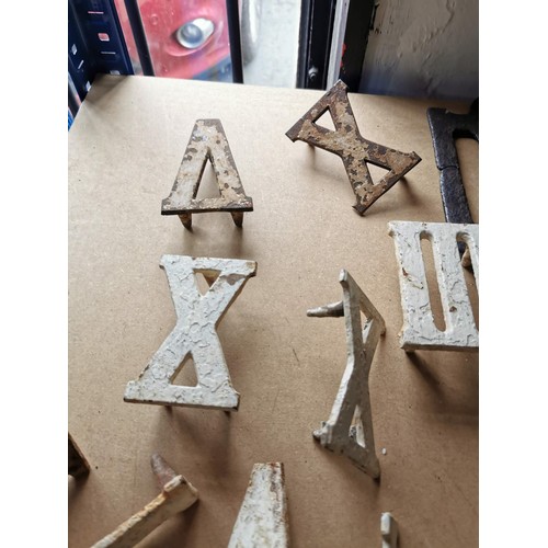 69 - Quantity of cast iron roman numerals possibly from an outdoor clock,  along with a cast iron triangl... 