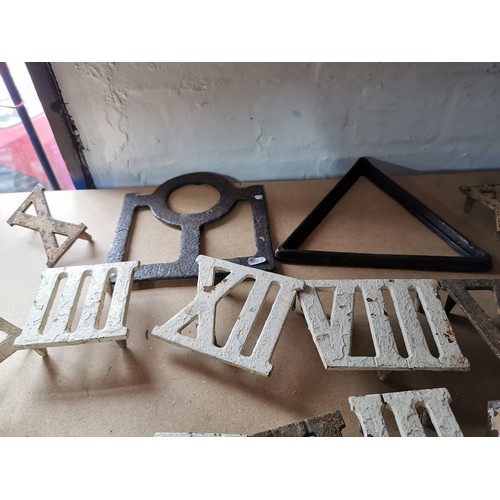 69 - Quantity of cast iron roman numerals possibly from an outdoor clock,  along with a cast iron triangl... 