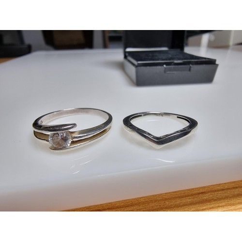 332 - A bundle of 2x 925 silver rings, 1 ring inset with a CZ crystal stone, the other has a signet pierce... 