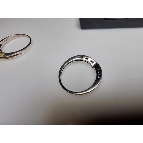 332 - A bundle of 2x 925 silver rings, 1 ring inset with a CZ crystal stone, the other has a signet pierce... 