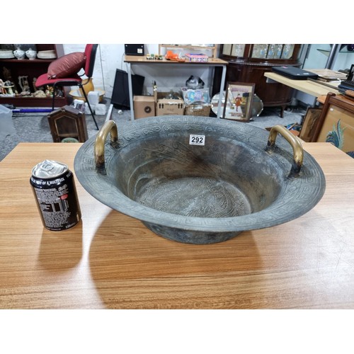 292 - A large antique Chinese bronze water basin with a dragon design featuring a ying yang and character ... 