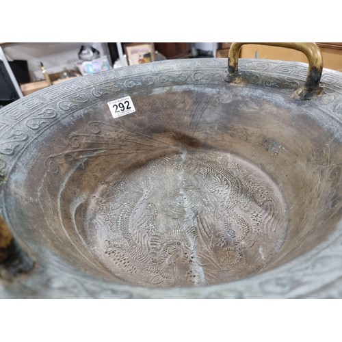 292 - A large antique Chinese bronze water basin with a dragon design featuring a ying yang and character ... 