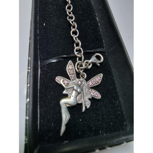 314 - A 925 silver bracelet with a fairy charm inset with pink CZ stones, in good clean condition and boxe... 