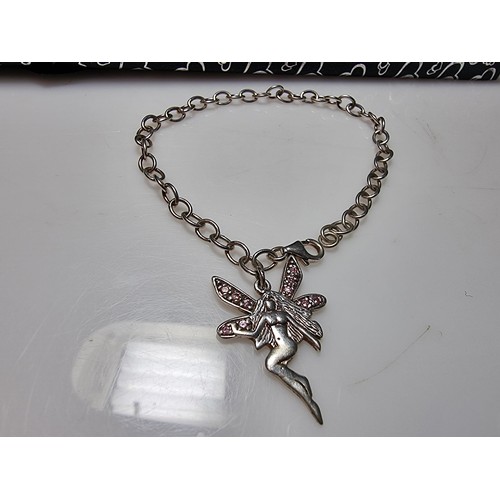 314 - A 925 silver bracelet with a fairy charm inset with pink CZ stones, in good clean condition and boxe... 