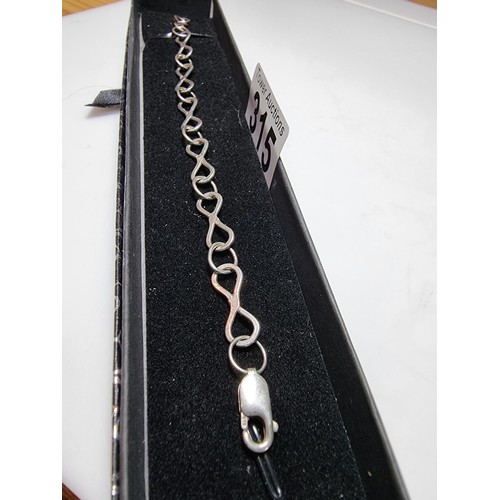 315 - A 925 silver bracelet with an infinity symbol link design, in good clean condition and boxed. Length... 