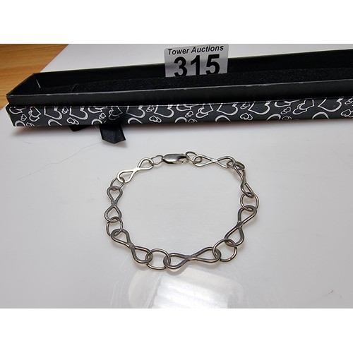 315 - A 925 silver bracelet with an infinity symbol link design, in good clean condition and boxed. Length... 