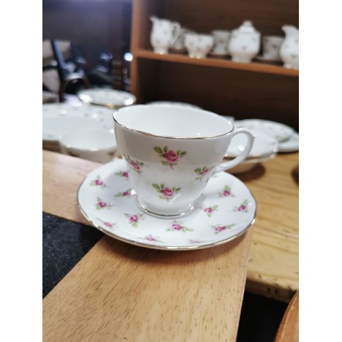 175 - Quantity of rosebud pattern dinner sets and tea sets, inc cups saucers cake plate, teapot, milk jug,... 