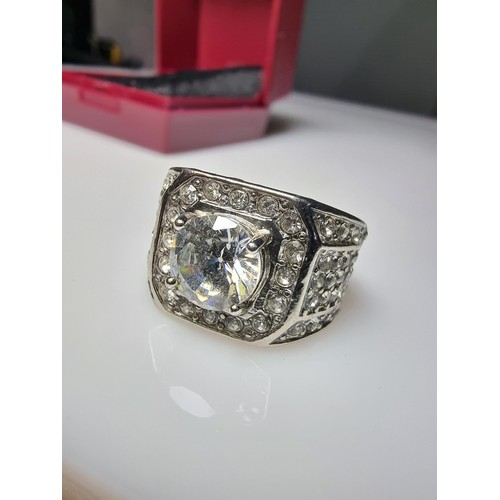 340 - A chunky 925 silver dress ring inset with a large quantity of crystal stones, in good condition and ... 