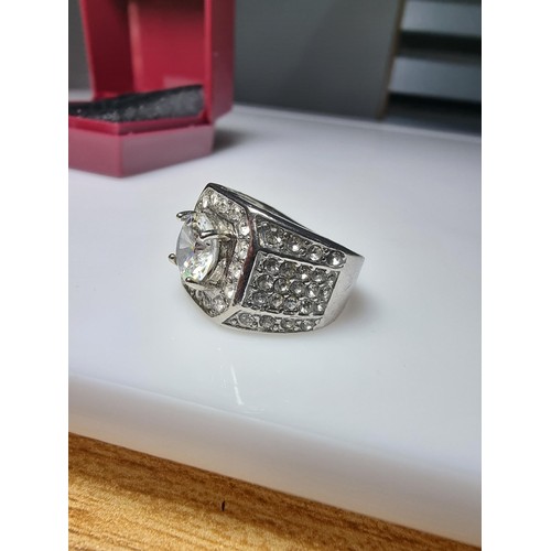 340 - A chunky 925 silver dress ring inset with a large quantity of crystal stones, in good condition and ... 