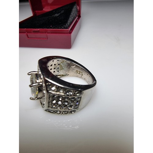 340 - A chunky 925 silver dress ring inset with a large quantity of crystal stones, in good condition and ... 