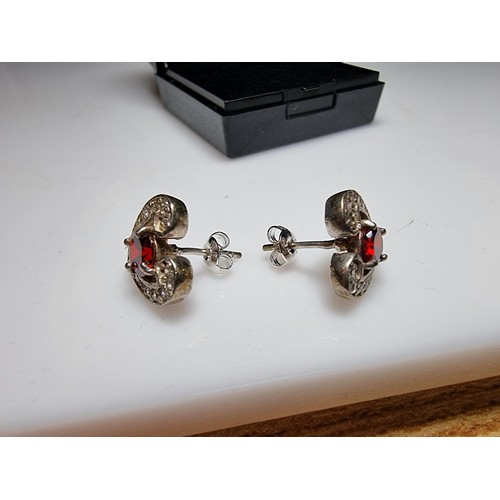 344 - A pair of pretty 925 silver heart formed stud earrings inset with large red stones and smaller white... 