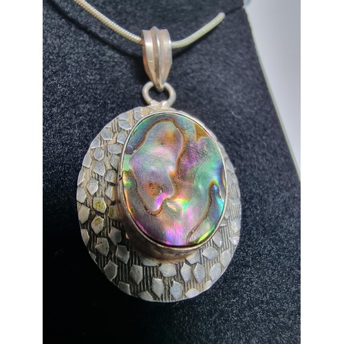 347 - A large 925 silver pendant inset with a large piece of abalone shell which presents good colours, se... 