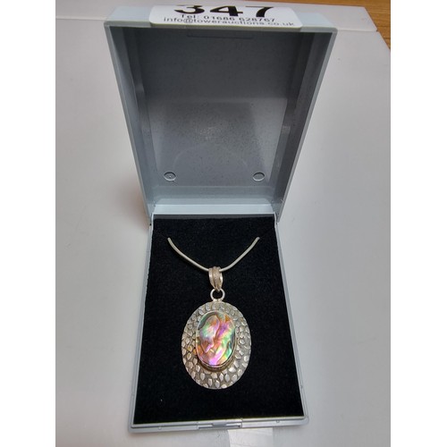 347 - A large 925 silver pendant inset with a large piece of abalone shell which presents good colours, se... 