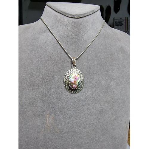 347 - A large 925 silver pendant inset with a large piece of abalone shell which presents good colours, se... 