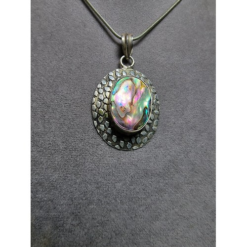 347 - A large 925 silver pendant inset with a large piece of abalone shell which presents good colours, se... 