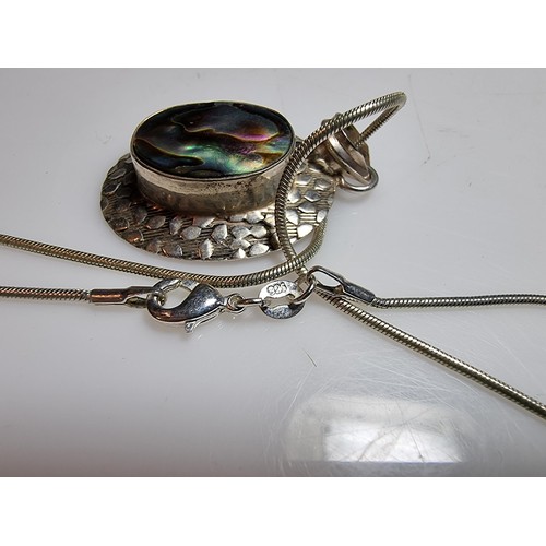 347 - A large 925 silver pendant inset with a large piece of abalone shell which presents good colours, se... 